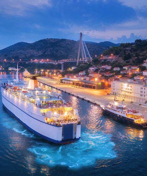 aerial-view-of-cruise-ship-at-harbor-at-night-small.jpg Coastal town with ferry at twilight